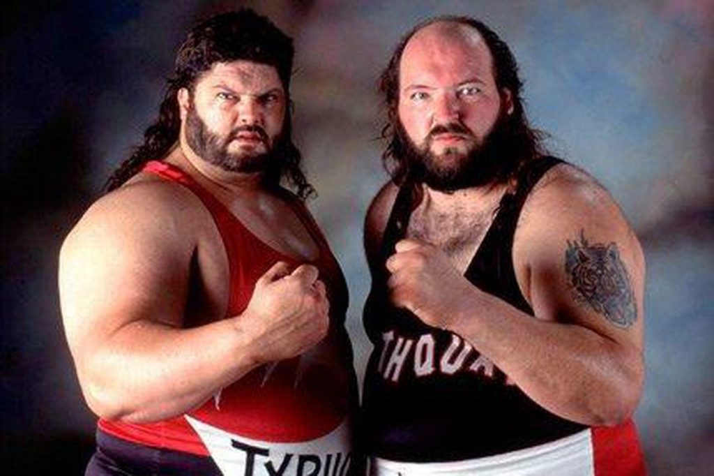 Fred Ottman, John Tenta are posing for a picture